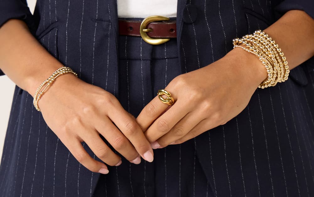 Image of woman wearing a stack of enewton bracelets