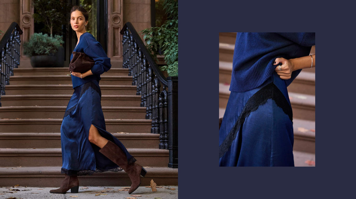Woman wearing a cobalt blue cashmere sweater with a blue satin skirt with black lace trim.