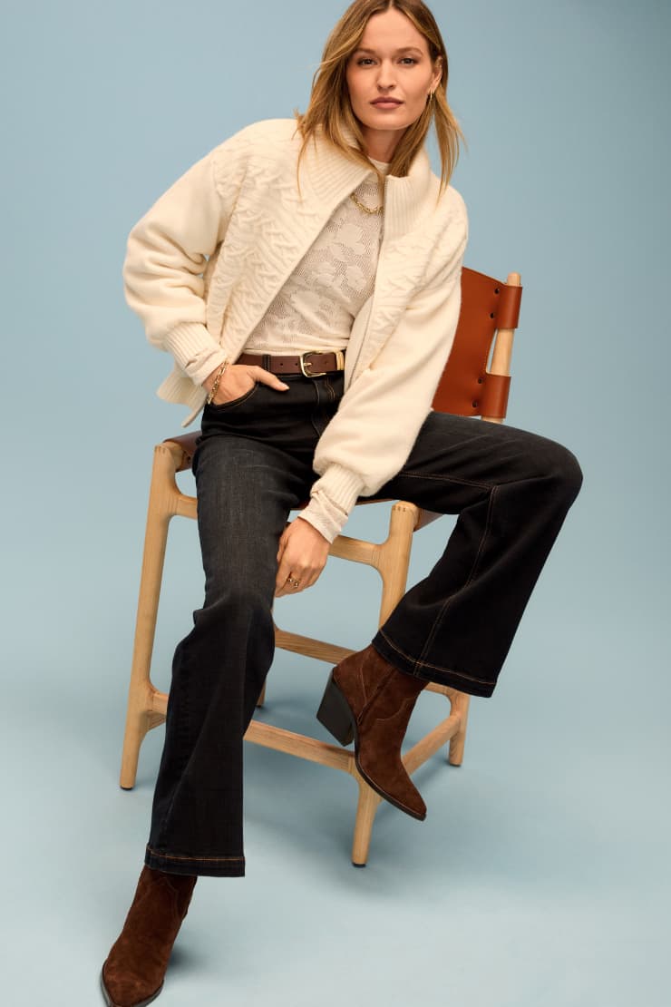 Image of woman wearing Kut From The Kloth jeans with an ivory sweater.