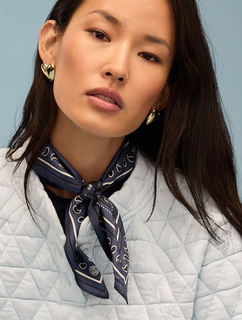 Image of woman wearing a bandana style scarf around her neck