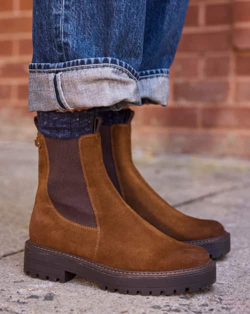 Woman wearing brown chelsea boots