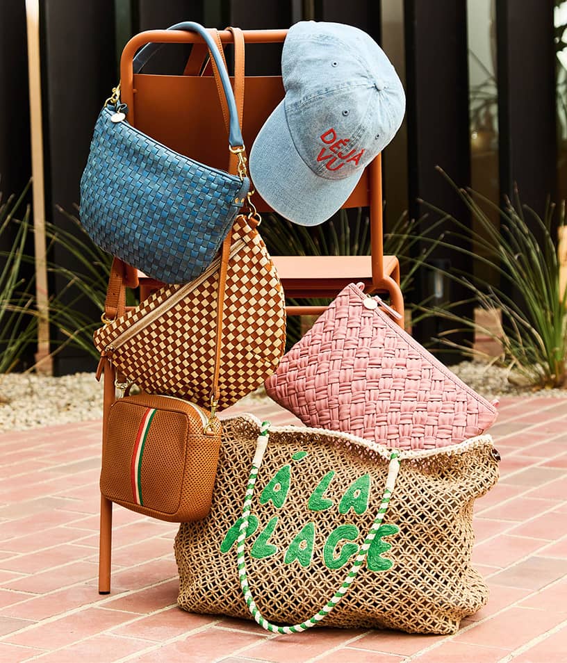 Image of a stack of Clare V. woven handbags