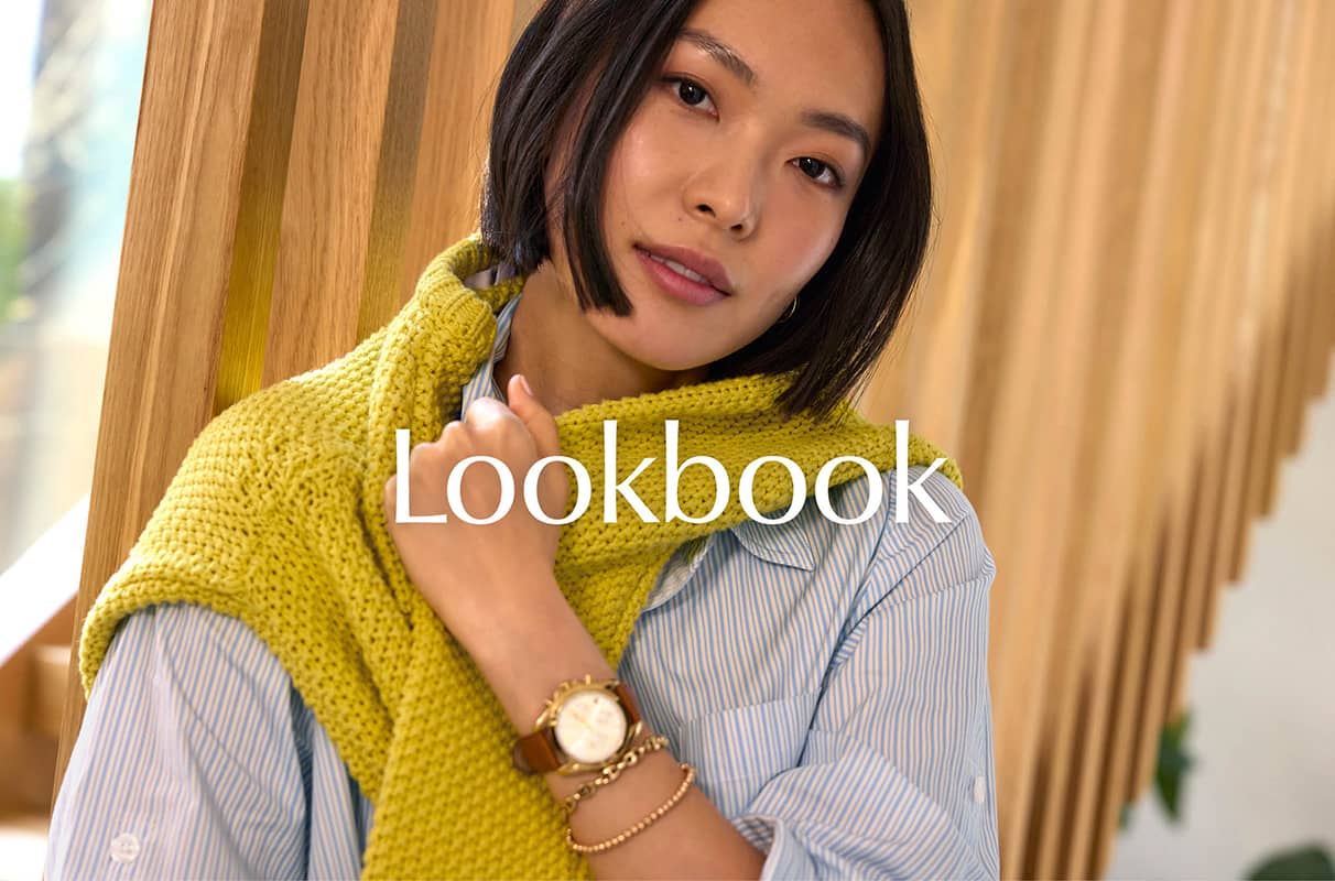 Image of woman wearing a blue button down and citron sweater worn over her shoulders