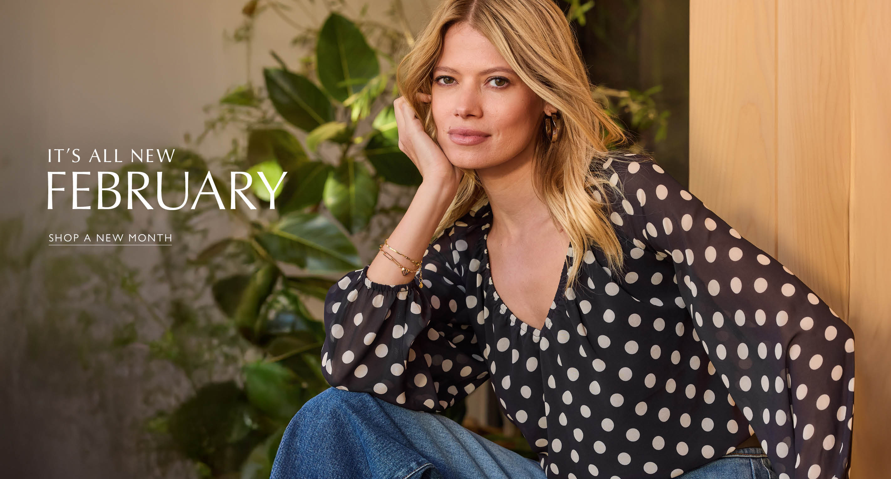 Image of woman in polka dot blouse. Text reads It’s all new February, Shop a new month