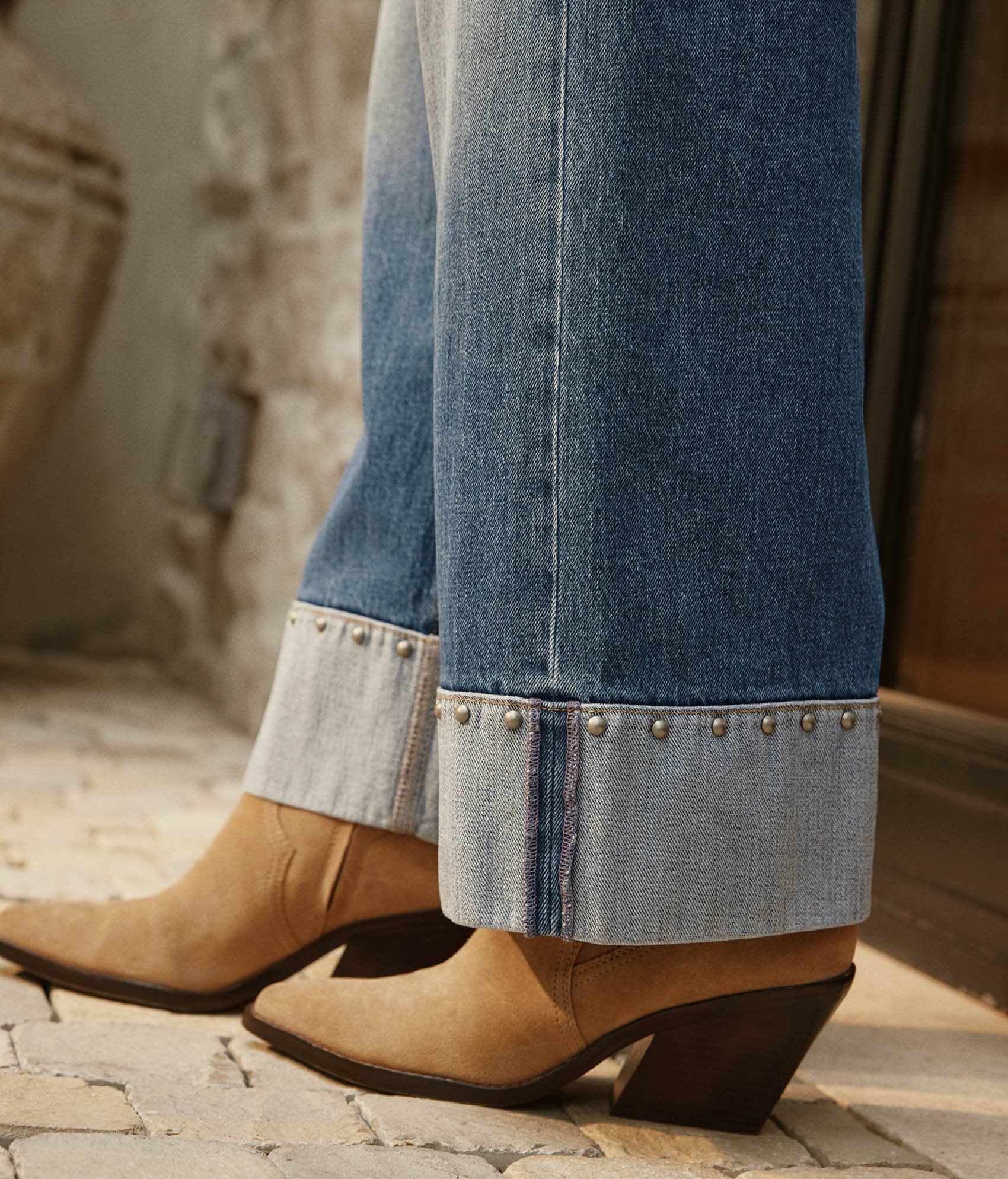 Image of woman wearing studded jeans with boots