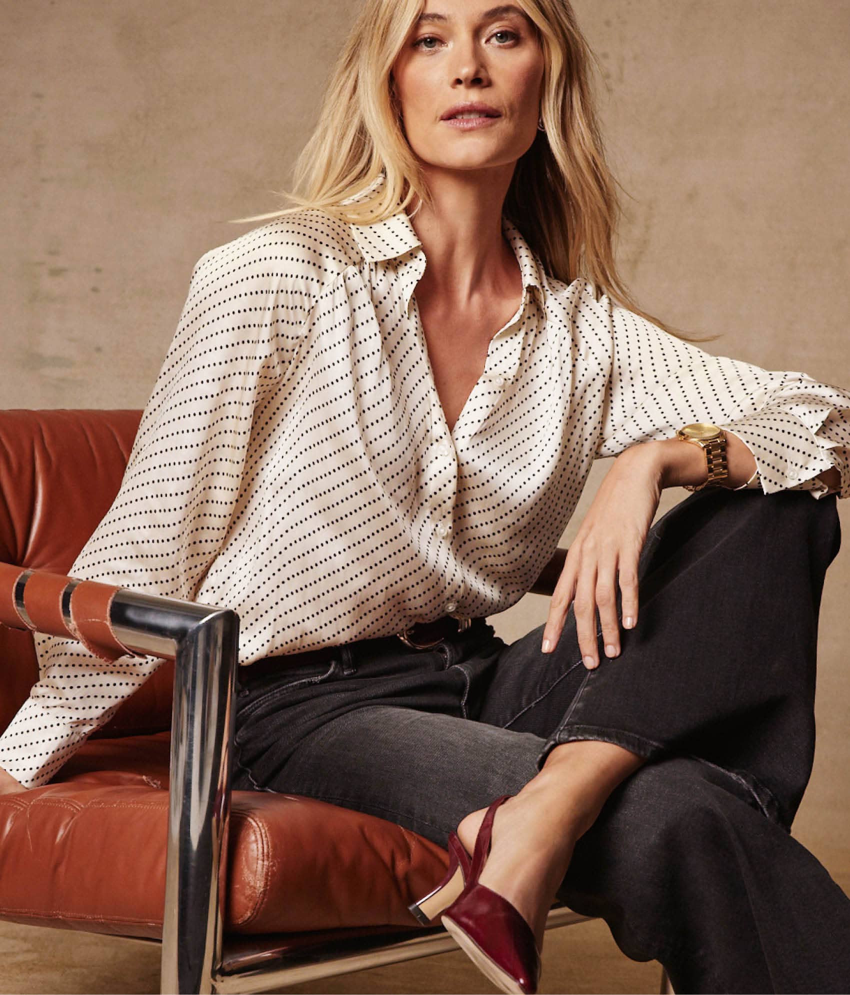 Image of woman wearing a printed blouse with jeans