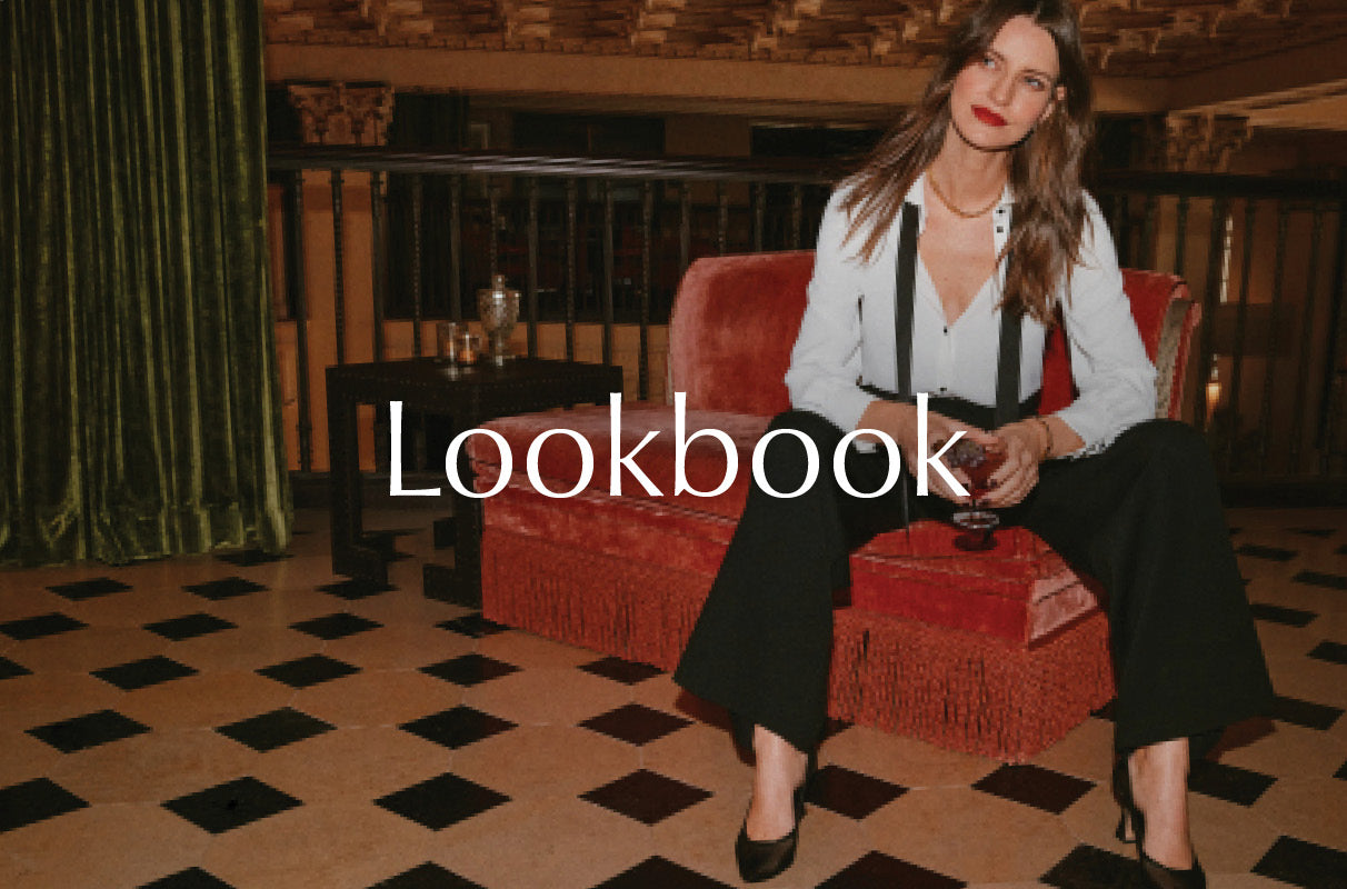 Image of woman wearing tuxedo pants with a black jacket and a black tie