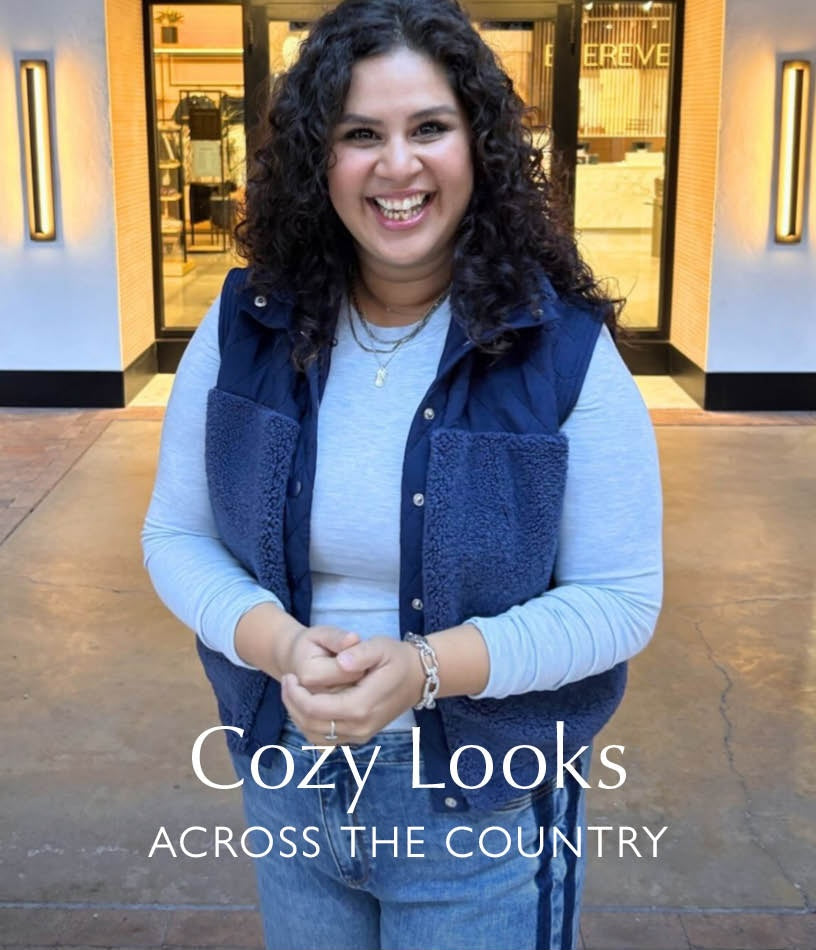 Image of woman wearing a sherpa vest with tuxedo stripe jeans