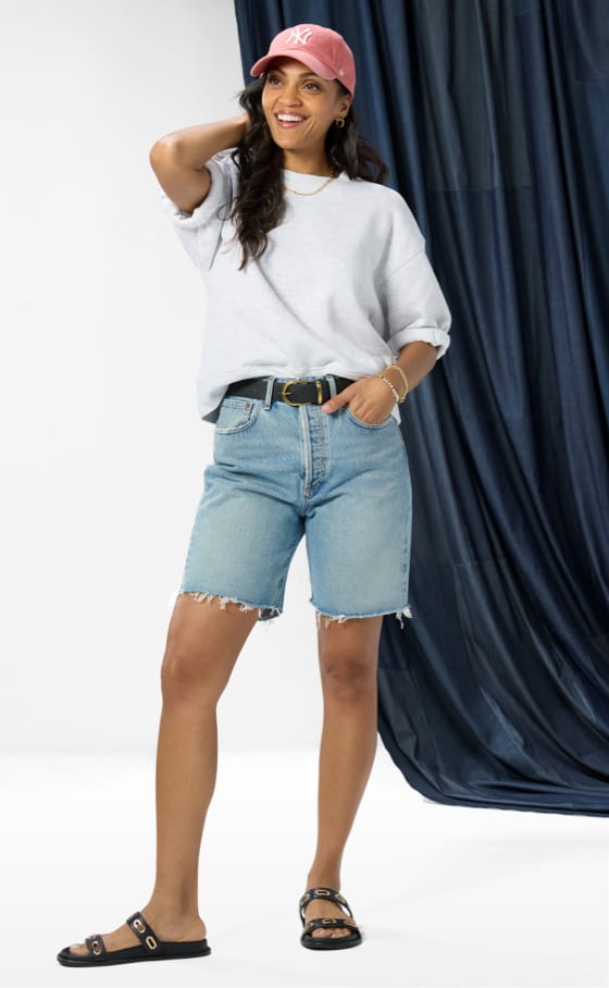 Image of woman wearing mid length denim shorts