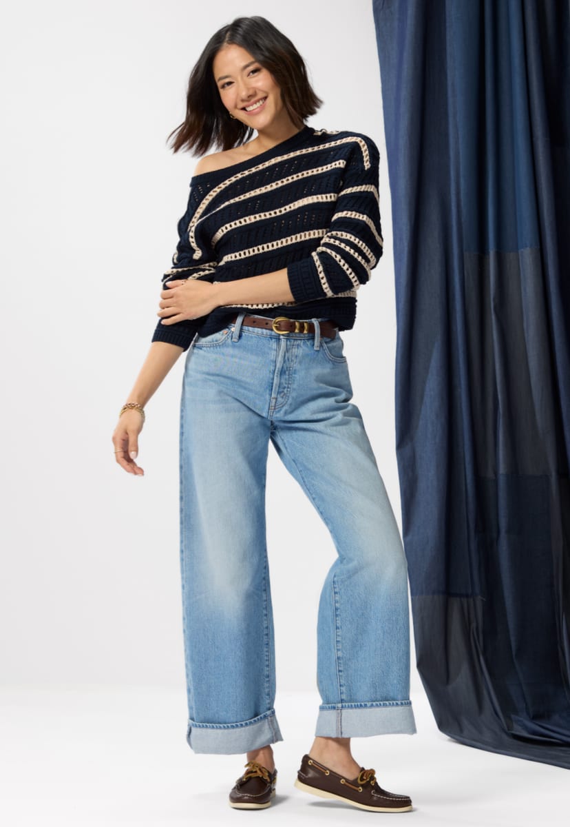 Image of woman wearing petite wide leg jeans with a cuff