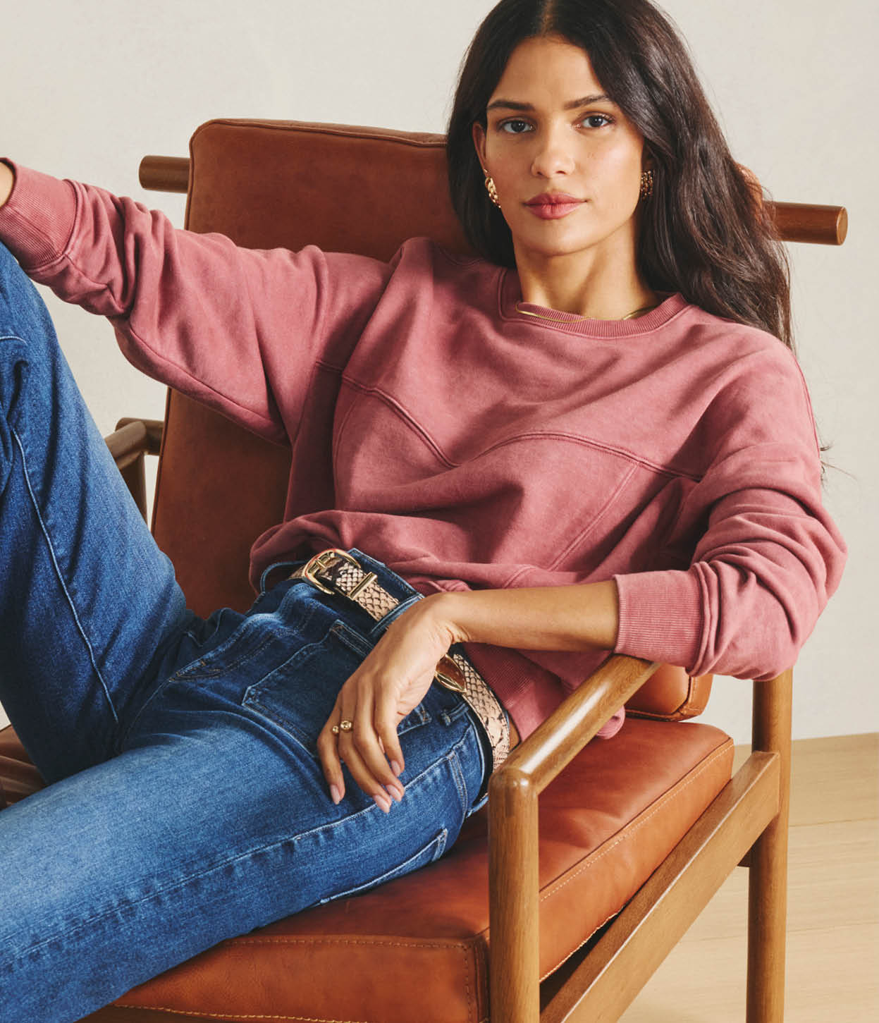 Image of woman wearing pink sweatshirt with jeans