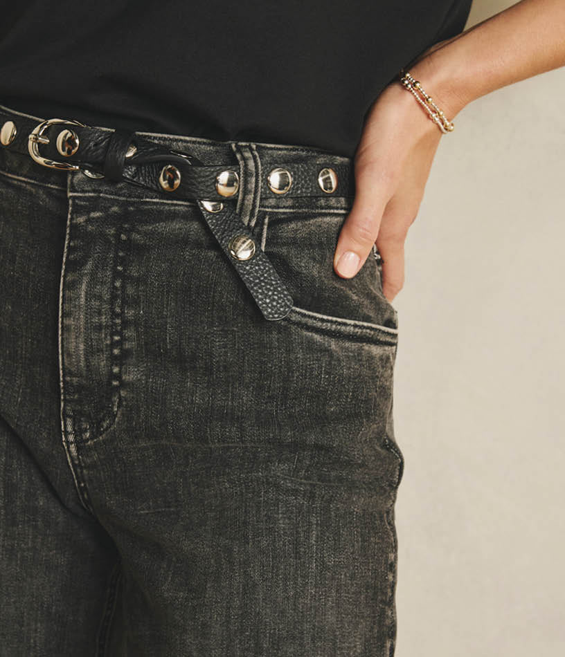 Image of woman wearing tan jeans with a grey sweatshirt