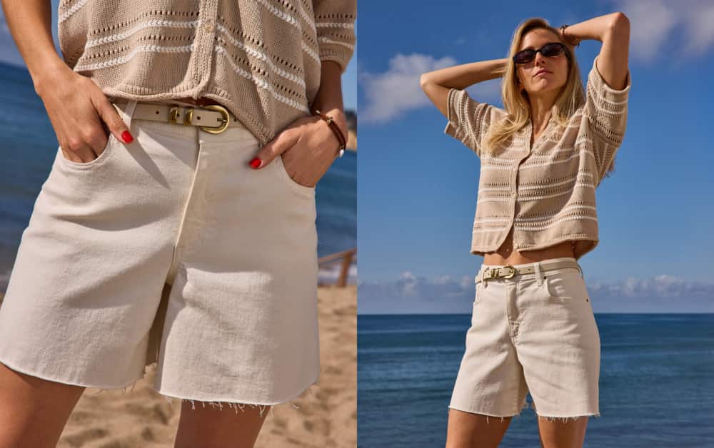Image of woman wearing a tan short sleeve cardigan with ivory jean shorts