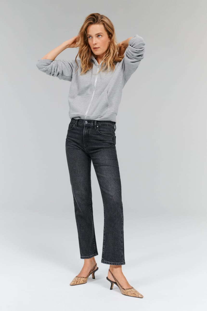 Image of woman wearing black straight leg jeans