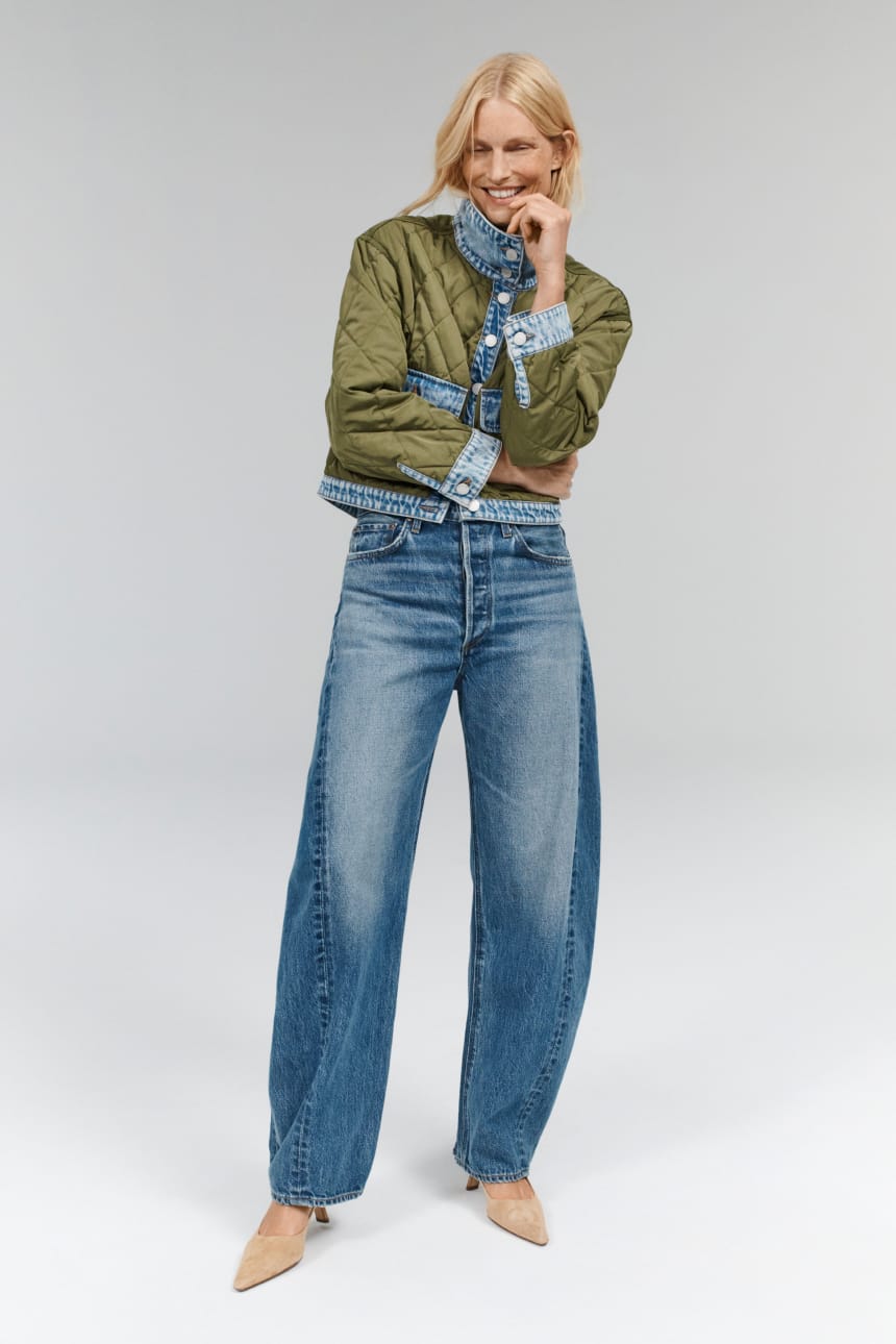 Image of woman wearing blue barrel leg relaxed jeans