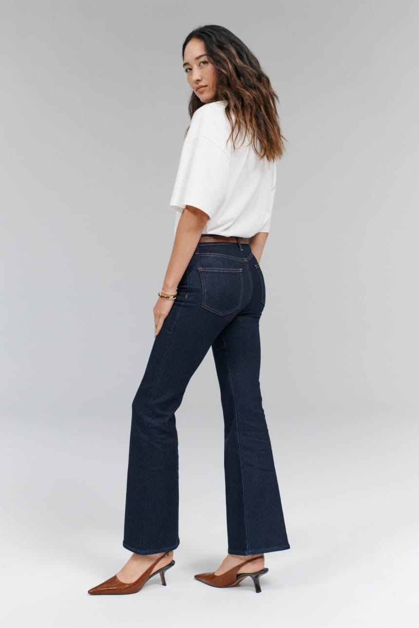 Image of woman wearing dark blue bootcut jeans