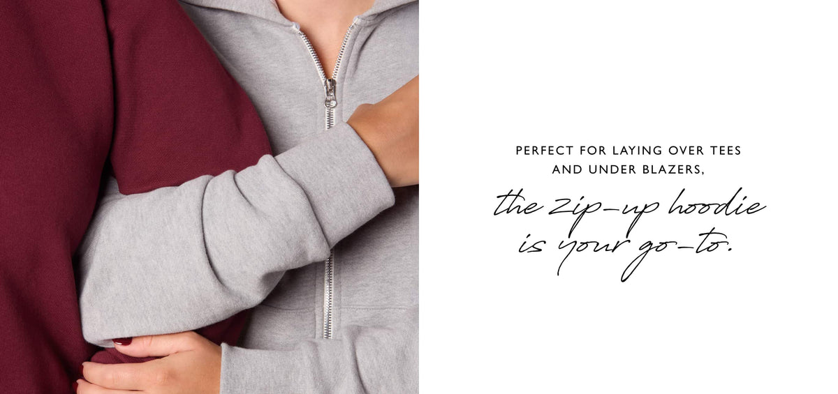 Image of two women wearing EVEREVe Heritage Collection zip up hoodies. 