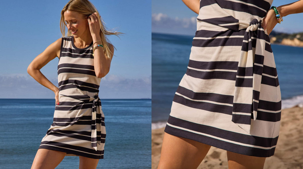 Image of woman on the beach wearing a striped dress. 