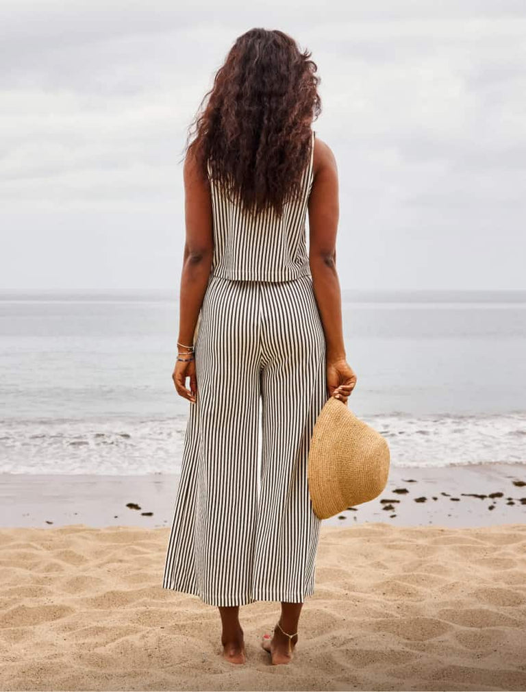 Image of woman wearing a striped tank and matching striped pants. 