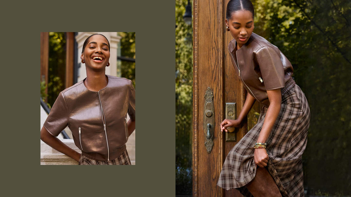 Woman wearing a short sleeve brown leather bomber jacket and plaid skirt. 