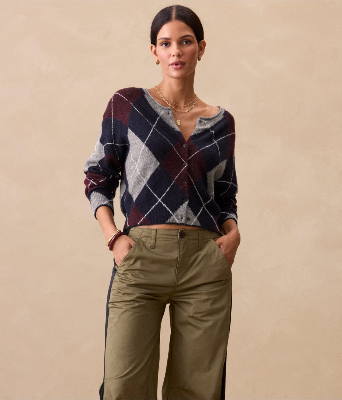 Woman wearing argyle cardigan sweater and olive green pants
