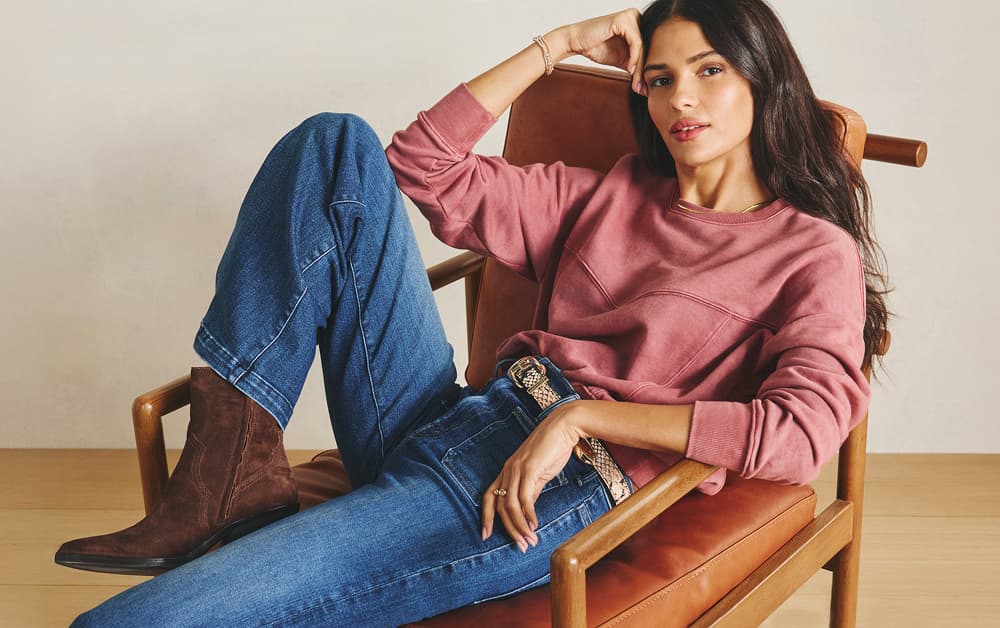 Image of woman wearing a red shirt with jeans and brown boots
