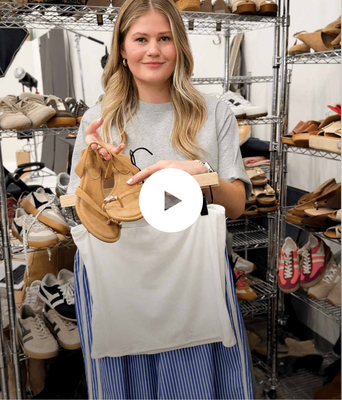 Image of woman wearing a grey tee and blue track pants