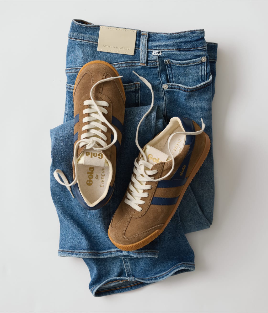 Blue jeans with brown suede Gola brand sneakers