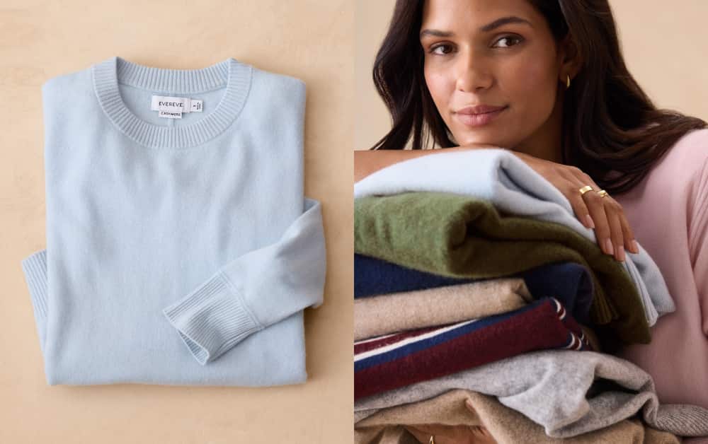 Woman holding a stack of folded cashmere sweaters