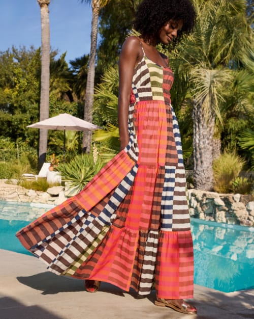 Image of woman wearing colorful stripe maxi dress. 