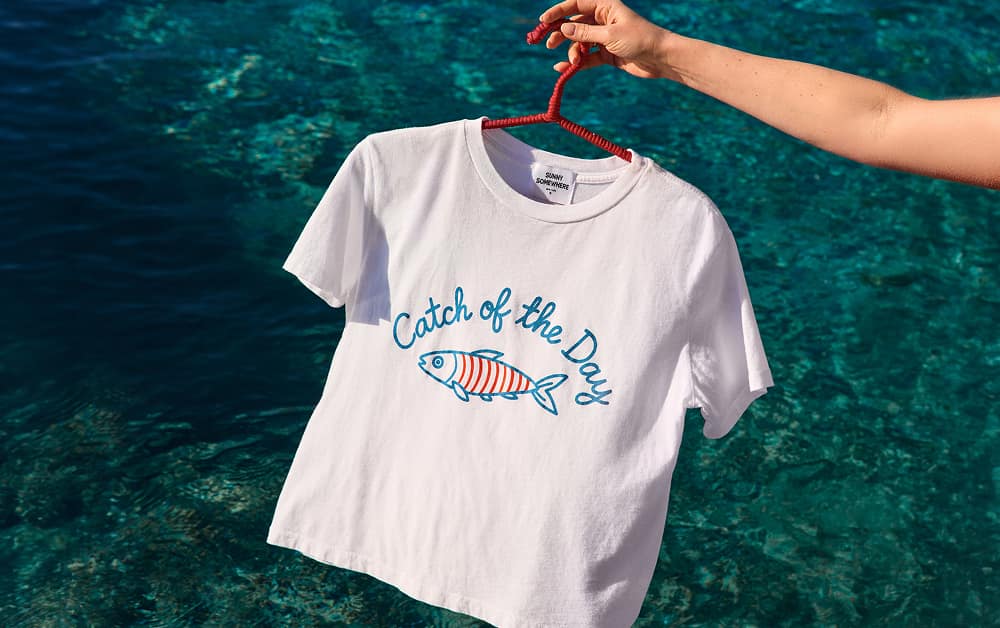 Image of graphic tee that says “catch of the day”