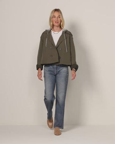 Woman wearing a crop trench coat with Miramar jeans by Rag and Bone. 